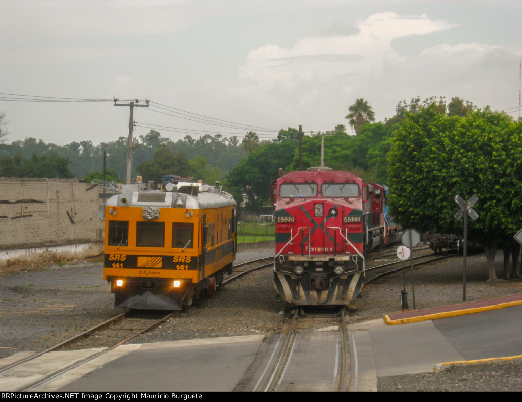 FXE AC4400 Locomotive leading a train and Sperry rail car